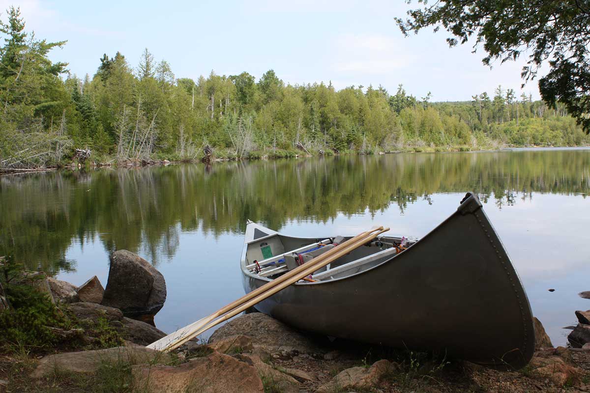 image of a canoe on the shore of a lake